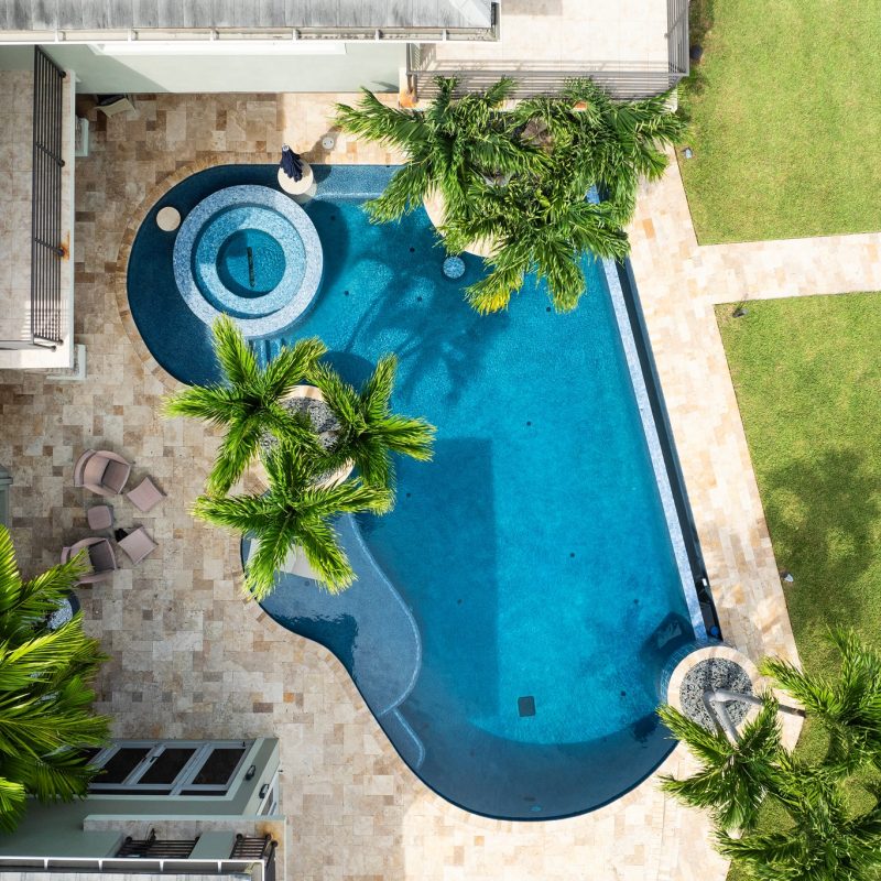 Custom designed curved edge pool with waterfall edge