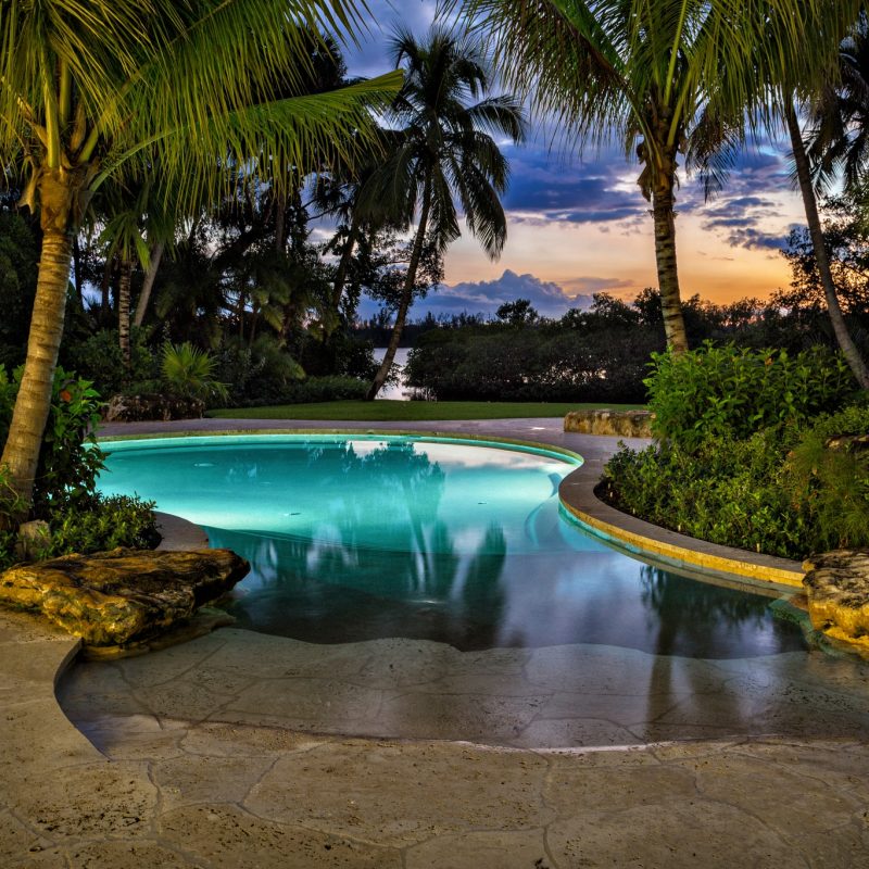 freeform swimming pool with spa in Martin County backyard